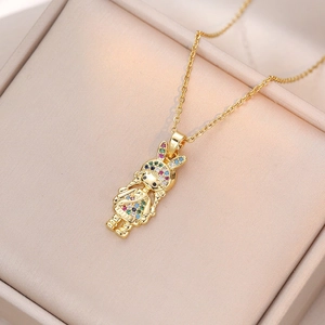 Golden necklace with colorful gemstone-studded bunny girl pendant in jewelry box