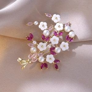Detailansicht der Blumenstrauß-Brosche mit weißen Perlmuttblüten und rosa Zirkon-Blättern
