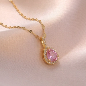 Gold heart pendant necklace featuring a teardrop pink stone and micro-inlaid zircons