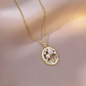 Elegant gold tulip pendant necklace with pearl and rhinestones on silk background
