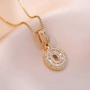 Elegant gold double oval pendant necklace with zircon crystals on premium silk background