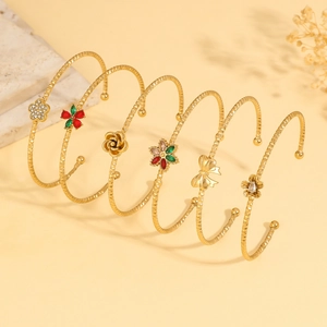 Gold plated six-piece flower and butterfly stackable bangle set with zircon accents