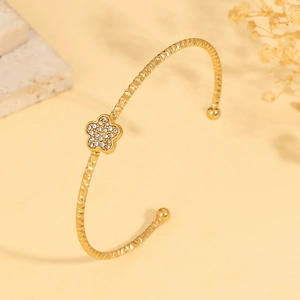 Macro shot of gold-plated butterfly flower cuff bracelet with sparkling zircon stones