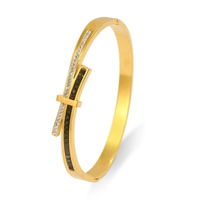 Detailed close-up of a gold-plated geometric bracelet with micro-pave crystals and black stones