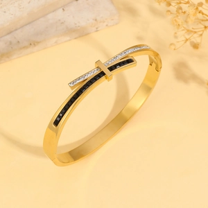 Minimalist gold bow knot steel bangle with black gemstones and micro pave crystals