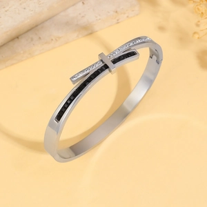 Detailed view of silver stainless steel bangle with pavé black and white crystals