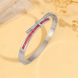 Detail of silver steel bracelet with micro-paved red square and white round cubic zirconia