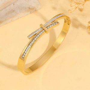 Modern gold plated stainless steel hinge bracelet featuring a criss-cross micro-pave design
