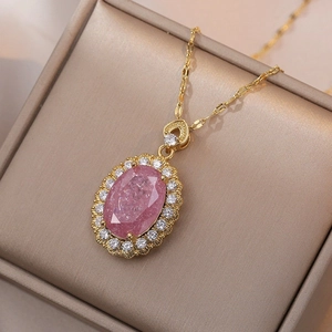 Elegant gold titanium necklace featuring an oval pink gemstone with white diamond halo