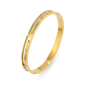 Vista macro del brazalete de acero inoxidable dorado con diamantes móviles y pulido