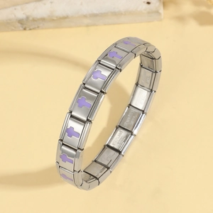 Detailed macro of stainless steel modular bracelet with purple cross charm and metal finish