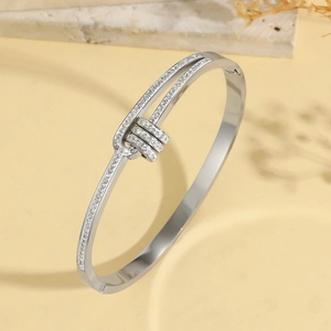 Silver titanium steel bangle with cubic zirconia stones and adjustable charm rings