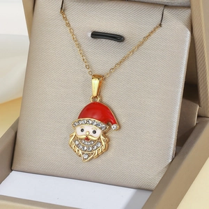 Detail of Christmas Santa Claus pendant with red enamel and sparkling rhinestones on gold chain