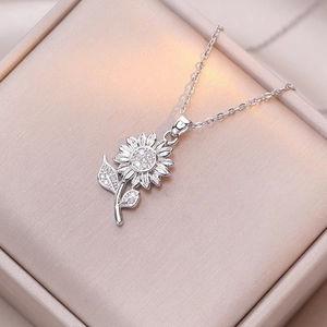 Silver sunflower pendant necklace with sparkling cubic zirconia in a jewelry box