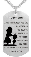 Détail macro du pendentif dog tag en acier brossé avec gravure silhouette mère et fils
