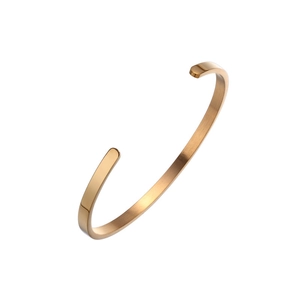 Detailed macro view of minimalist C-shape rose gold bangle with brushed metal finish