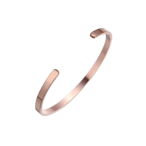 Detail view of rose gold C-shaped cuff bracelet with brushed finish and polished edges