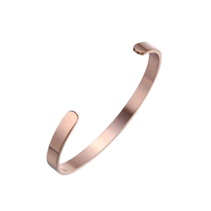 Detail view of rose gold minimalist C-shaped cuff bracelet with a brushed metal finish