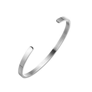 Close-up of a silver-toned C-shaped cuff bangle with a premium brushed metal finish