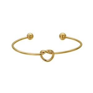 Eleganter goldener Knoten-Armreif mit polierter Oberfläche und zwei Kugeln auf Weiß