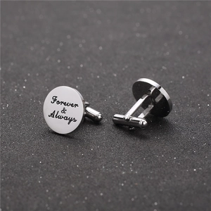 Detailed close-up of titanium steel cufflinks featuring Forever & Always engraving