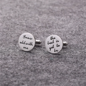 Macro shot of polished stainless steel cufflinks with custom romantic text engraving