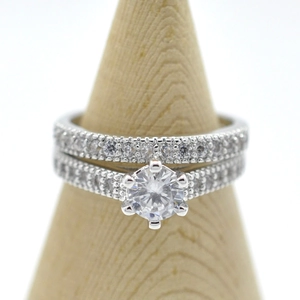Detailed macro view of a 6-prong crown engagement ring set on a wooden display stand