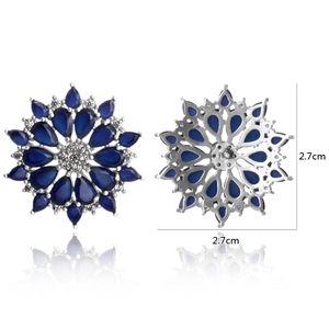 Detail of sapphire blue flower earrings featuring micro-paved zircons and 2.7cm dimensions