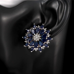 Elegant floral stud earrings featuring deep blue sapphire stones and 3A cubic zirconia