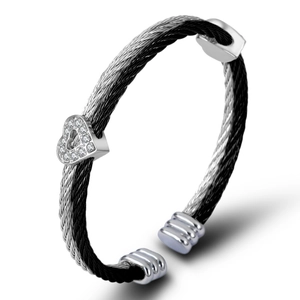 Two-tone cable twist bangle with heart charm and sparkling crystals in silver and black