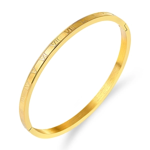 Macro detail of gold-plated Roman numeral bangle with a modern brushed metal texture