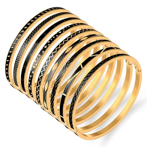 Set di 12 bracciali in acciaio al titanio dorato con smalto nero e motivi geometrici
