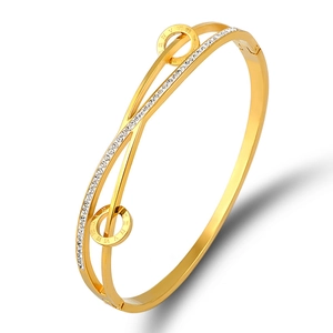 Gold stainless steel Roman numeral bangle featuring pavé-set crystals and dual-strand design