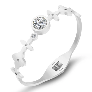 Polished titanium steel bangle with central zircon crystal and floral hollow design