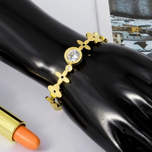 Rose gold zircon bangle with flower-shaped links and large round crystal stone