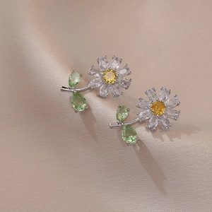 Daisy flower earrings with yellow zircon center and green leaf accents in silver finish