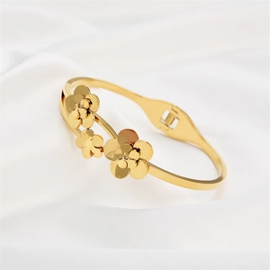 Rose gold flower bangle in titanium steel with zircon crystals on white silk background