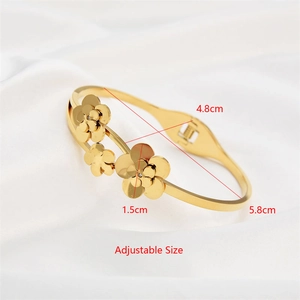 Close-up of rose gold flower bangle with crystal inlay on white silk background