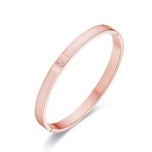 Minimalist matte rose gold stainless steel bangle with a single diamond-cut crystal accent