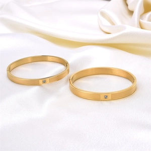 Minimalist matte gold titanium steel bracelet set with single diamond and hinged clasp