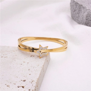 Elegant gold titanium steel open bangle with a sparkling cubic zirconia star design
