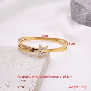 Detail showing dimensions of gold star crossover bangle with 5.8cm diameter and zircons