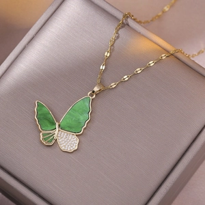 Golden butterfly necklace with green marble wings and shimmering pavé zircon accents