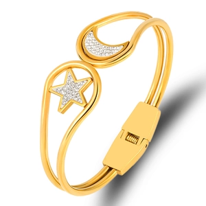 Gold stainless steel open bangle featuring crystal-studded star and moon charms