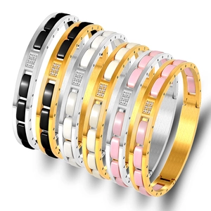 Stack of gold and silver stainless steel ceramic bracelets with zircon square inlays