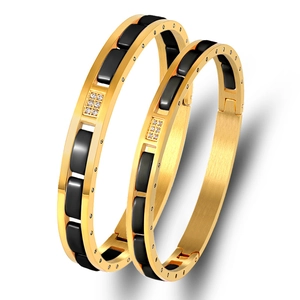 Golden stainless steel bangles with black ceramic inlay and sparkling zircon crystals