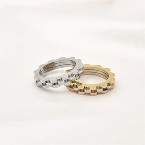 Detailed view of polished wave edge titanium steel rings in silver, gold, and rose gold
