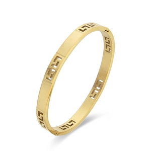 Elegant gold titanium bangle featuring Greek key cutout patterns and a side clasp