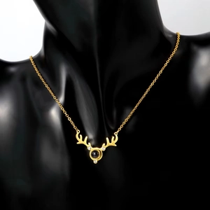 Golden stag antler projection necklace with 100 languages I Love You on black bust