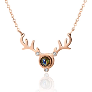 Rose gold reindeer antler projection necklace with sparkling crystal and round gemstone